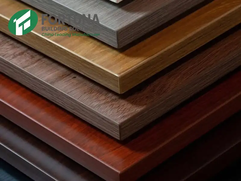 A stacked display of wood grain MDF panels (medium density fibreboard) in various finishes from a leading MDF manufacturer, showcasing high-quality textures and professional edge banding.