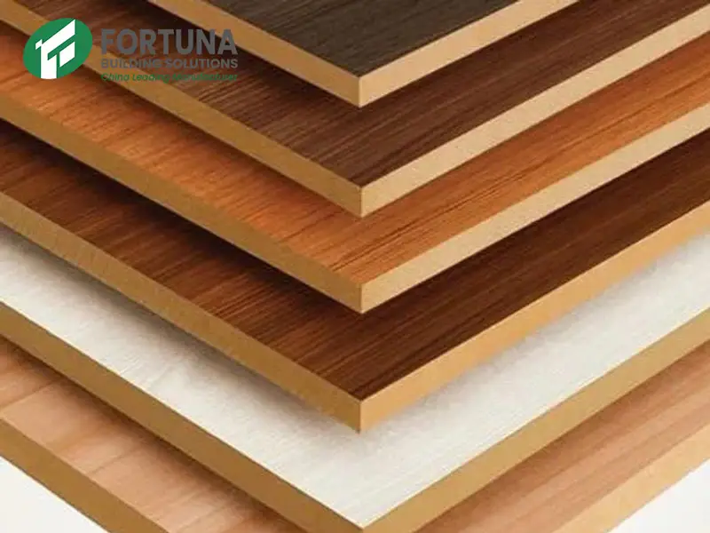 Stacked laminated MDF panels showing various wood grain surface finishes and the raw cross-section of the medium density fibreboard core, manufactured by a leading MDF manufacturer---Fortunaply.