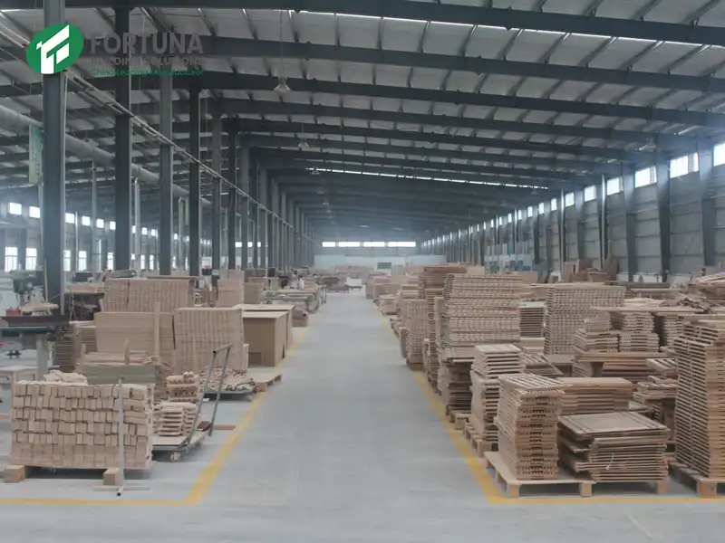 A spacious factory warehouse with massive stock of plain chipboard, showcasing Fortuna's capacity as a leading particle board manufacturer and wholesale supplier